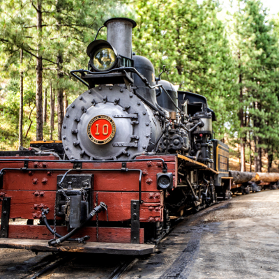 a steam engine is sitting on a train track