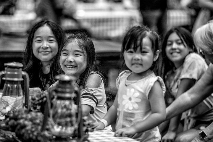 a little girl sitting on a table