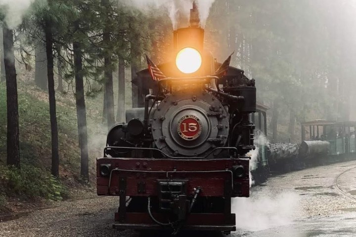 a train on a track with smoke coming out of it