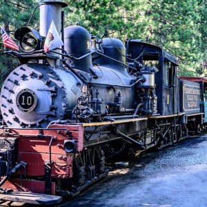 a steam engine train traveling down train tracks