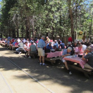 a group of people sitting on a bench in a park