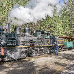 a steam train on a track with smoke coming out of it