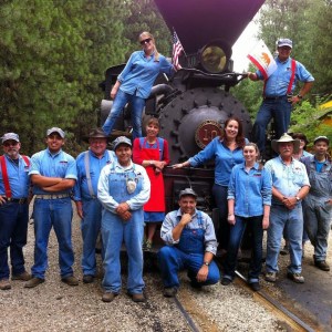 a group of people standing in front of a crowd posing for the camera