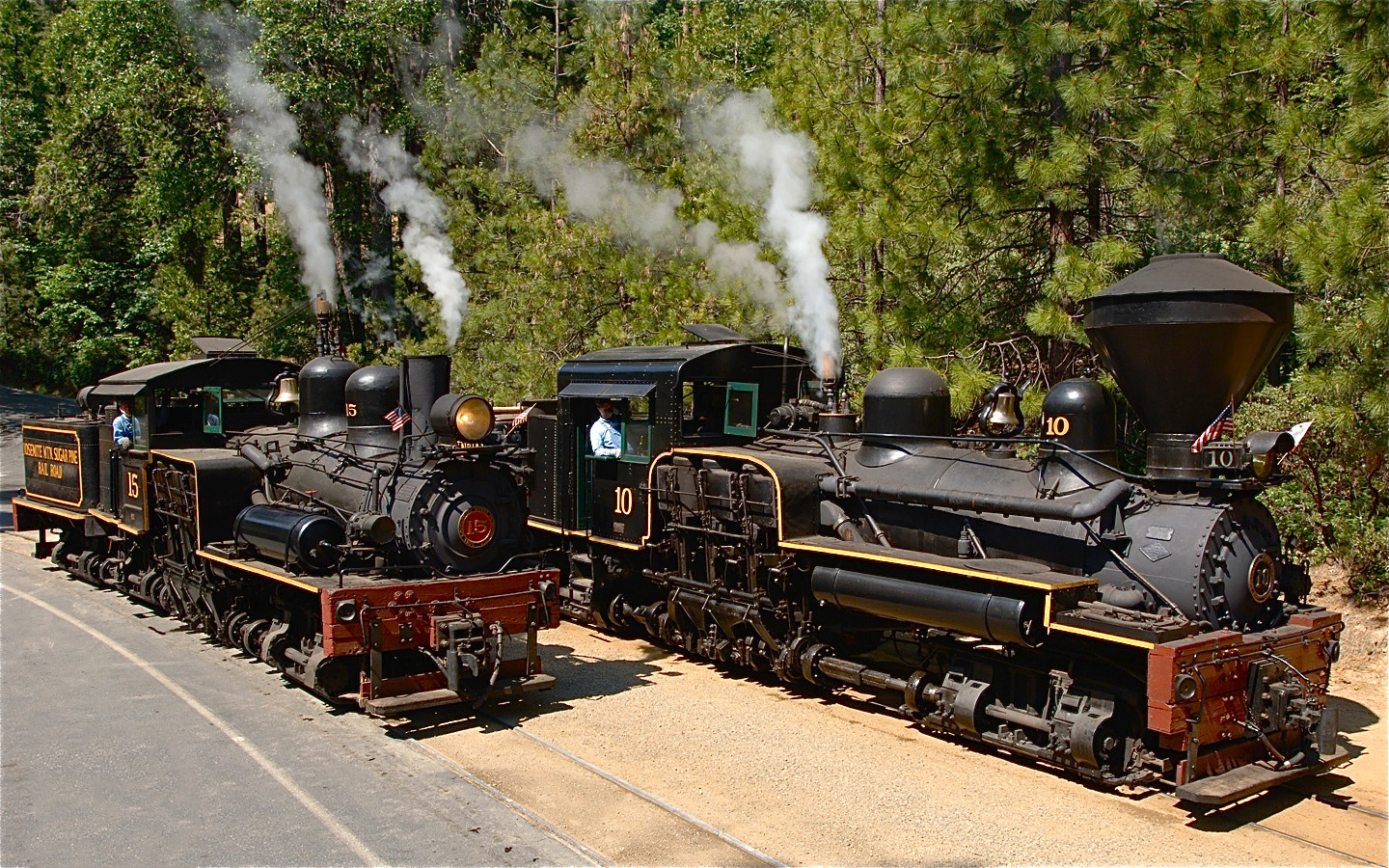 a steam train on a track with smoke coming out of it