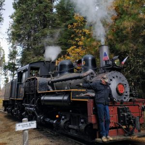 a steam train on a track with smoke coming out of it