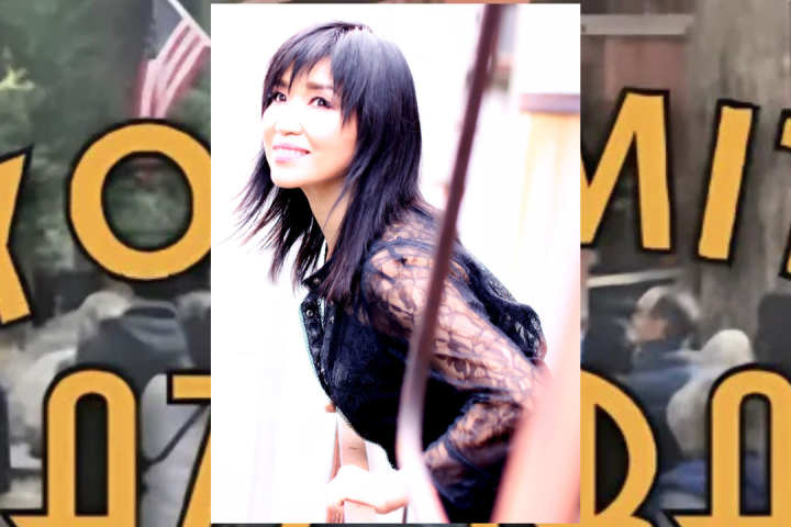 Keiko Matsui holding a sign