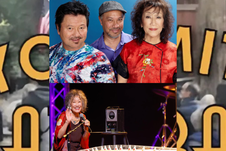 a group of young children sitting next to a building