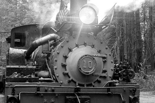 a steam engine is sitting on a train track