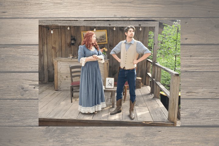 Man and woman in vintage clothing on wooden porch.